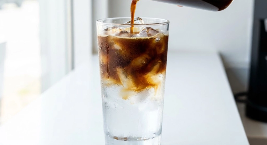 Iced Americano with espresso poured over ice and cold water